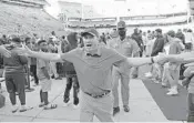  ?? JOHN RAOUX/AP ?? Florida head coach Dan Mullen celebrates with fans Saturday after the Gators’ 70-52 win over Samford.