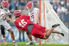  ?? ?? Cornell attack CJ Kirst (15) shoots and scores a goal past Rutgers goalie Colin Kirst Saturday’s 17-10 win in the NCAA semifinals at Rentschler Field.