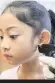  ??  ?? A girl has her ears pierced