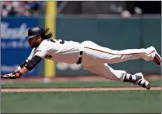  ??  ?? San Francisco Giants’ Brandon Crawford slides safety into third base with an RBI-triple during the fourth inning of a baseball game against the San Diego Padres on Saturday in San Francisco.
AP Photo/mArCIo JoSe SAnChez