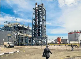  ?? Picture: AFP PHOTO ?? OUT THE BOX: This methane power plant at Lake Kivu that opened on Monday is intended to provide 60% of Rwanda’s electricit­y. It will turn the vast quantities of methane and carbon dioxide trapped in the lake into power and is an example of the...