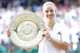  ??  ?? MICHAEL STEELE/GETTY IMAGES Angelique Kerber poses with her Wimbledon trophy after defeating Serena Williams in the final in All England Lawn Tennis and Croquet Club in London, Britain, on July 14, 2018.