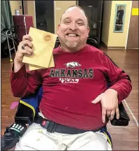  ?? Special to the Democrat-Gazette ?? Jason Sasser proudly displays a board he broke while training with tae kwon do instructor Holly Hardin of Memphis in December. “I just remember crying my head off because I never in a million years thought that I would be able to do something like...