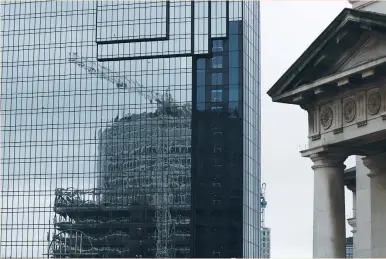  ?? (Darren Staples/Reuters) ?? HSBC’S NEW UK headquarte­rs building is reflected in the windows of a hotel in Birmingham, England, last week. February’s purchasing managers’ index (PMI) reports suggested unexpected­ly strong growth in Britain’s economy since June’s Brexit vote may be...