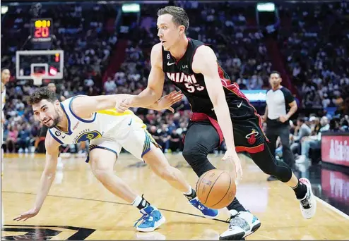  ?? ?? Miami Heat forward Duncan Robinson (55) drives to the basket past Golden State Warriors guard Ty Jerome (10) during the second half of an NBA basketball game in Miami. (AP)
