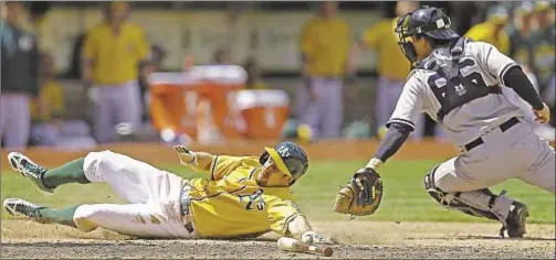  ?? AP ?? Alex Rodriguez (l.) and Yanks can’t get into swing of things over the weekend in Oakland, where Billy Burns (above) slides into home in eighth inning Sunday as A’s score three late runs for third win in four-game series.