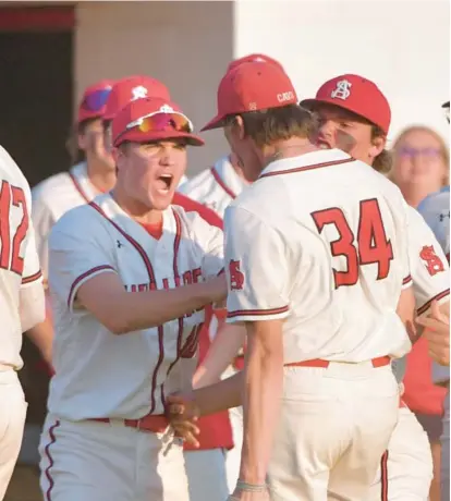  ?? AMY DAVIS/BALTIMORE SUN ?? Dillon Stoltzfus, left, congratula­tes relief pitcher Nathan Wines, who shut down Calvert Hall in the seventh inning of a 4-3 victory Wednesday in the MIAA A Conference winner’s bracket.