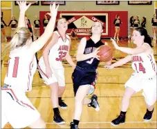  ?? PHOTO BY RICK PECK ?? McDonald County’s Samantha Frazier drives through a trio of Aurora defenders for two of her 10 points in the Lady Mustangs’ 49-44 loss on Monday night in the Missouri Class 4 District 10 Basketball Tournament at MCHS.