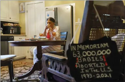  ?? DAVID GOLDMAN — THE ASSOCIATED PRESS ?? Tanya Britton prays before lunch in her kitchen in Tupelo, Miss., on May 24. “Whatever I do, let it be for the end of abortion,” 70-year-old Britton prays. “Let it be that one child be saved today. Let it be that Roe v. Wade be overturned.”