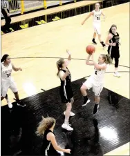  ?? PHOTOS BY MARK HUMPHREY ENTERPRISE-LEADER ?? Prairie Grove senior Jordan Sugg gets off a running shot in the paint with teammate Jasmine Wynos securing inside position. Head coach Kevin Froud prefers shots over turnovers, yet implores the 2018-2019 Lady Tiger girls basketball team to make good shot selection.