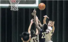  ?? BOB TYMCZYSZYN/STANDARD STAFF ?? St. Paul Patriots Victor Kariuki (22) goes up to the net against the Welland Centennial Cougars in the Review boys basketball final Friday at Westlane Secondary School.