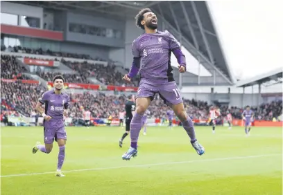  ?? Picture: Getty Images ?? HIGH JUMP. Liverpool’s Mohamed Salah celebrates after scoring a goal during their English Premier League match against Brentford at the Gtech Community Stadium on Saturday.