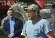  ??  ?? Farmer Dave Wolfskill, right, speaks to reporters at MarAnne Farms in Lower Heidelberg Township April 20. He drove his tractor and corn planter in a demonstrat­ion to promote Rural Roads Safety Week. Pennsylvan­ia Farm Bureau President Rick Ebert is at left.