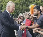  ?? Yui Mok Pool Photo ?? BRITAIN’S King Charles III greets well-wishers outside the gates of Buckingham Palace on Friday, a day after the death of his mother, Queen Elizabeth II.