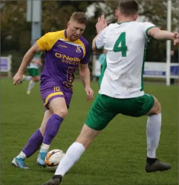  ??  ?? Paul Murphy on the ball for Wexford as Conor Marlow of the Defence Forces closes in.