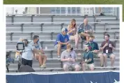  ?? DAVID BANKS/AP ?? Fans watch from the rooftops across from Wrigley Field as the Cubs open against the Brewers.