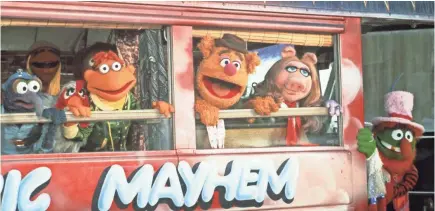  ?? FATHOM EVENTS ?? Gonzo (from left), Camilla, Scooter, Fozzie Bear, Miss Piggy and Dr. Teeth climb aboard the Electric Mayhem Bus in “The Muppet Movie.”