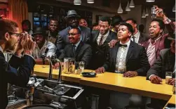  ?? Amazon Studios ?? Kingsley Ben-Adir as Malcolm X, far left, takes a photo of Aldis Hodge (standing, center, in white shirt and tie) as Jim Brown, Eli Goree (in tuxedo) as Cassius Clay and Leslie Odom Jr. (raising glass) as Sam Cooke in “One Night in Miami.”