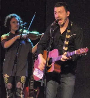  ??  ?? Lead vocalist and guitarist Andrew Morrison and violinist Gina Burgess perform during The Jerry Cans concert in Swift Current, Jan. 18.