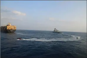  ?? (AP/Indian Navy) ?? A firefighti­ng team from the INS Kolkata responds Tuesday to a fire on Liberian-flagged Merchant ship MSC Sky II due to a suspected drone/missile attack in the Gulf of Aden.