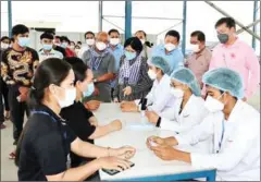  ?? FB ?? Health ministry spokeswoma­n Or Vandine (centre right) checks progress at a vaccinatio­n centre in Svay Rieng province on Saturday.