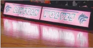  ?? MARK HUMPHREY ENTERPRISE-LEADER ?? Lincoln’s official scorer’s table lights up during pregame introducti­ons for starting lineups as Friday’s Colors Day ceremony gave way to basketball action.