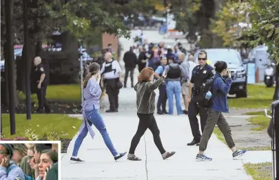  ?? STAFF PHOTO BY NICOLAUS CZARNECKI ?? FEAR AND CHAOS: Police evacuate students, above and left, after reports of shots fired at Simmons University yesterday. Police determined the sound heard was that of balloons popping.