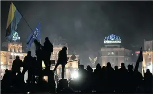  ?? —GETTY IMAGES ?? People stand on a truck as thousands gather in Kyiv’s Independen­ce Square to hear the lineup of the new pro-Western cabinet Wednesday.