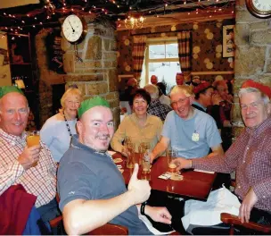  ??  ?? ●● The walk was led by David Gylee, pictured here second from right at the Christmas lunch at the Church House Inn