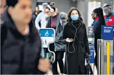  ??  ?? A masked passenger at Waterloo Undergroun­d station yesterday