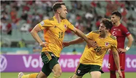  ??  ?? Wales midfielder Aaron Ramsey, left, celebrates his goal against Turkey