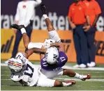  ?? AP Photo/John Raoux ?? ■ Auburn defensive back Marco Domio, left, tackles Northweste­rn wide receiver Bryce Kirtz after a reception during the first half of the Citrus Bowl Friday in Orlando, Fla.