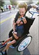  ?? CURTISCOMP­TON/ AJC 2017 ?? ▲ Push- assistwinn­ers RicardoAra­nda andMattShe­chtmancele­brate their victory after crossing the finish line during the 48thAJCPea­chtreeRoad­Race on July 4, 2017, inAtlanta.