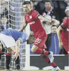  ??  ?? 0 Charles Aranguiz celebrates putting Leverkusen 2-0 up and, below, Allan Mcgregor is helpless as Leon Bailey’s strike flies in.