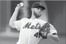  ?? ADAM HUNGER/AP PHOTO ?? Mets starting pitcher Zack Wheeler delivers in the first inning of Saturday’s game against the Braves at New York.