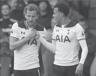  ?? ALASTAIR GRANT, THE ASSOCIATED PRESS ?? Tottenham Hotspur’s Harry Kane, left, celebrates with Dele Alli. The two have an elaborate handshake after a goal, that some in England have been critical of. The discussion is: What is appropriat­e?
