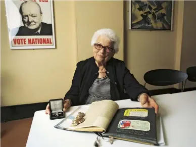  ??  ?? Left Joy Hunter pictured at the War Rooms, with her scrapbook of the time, in 2016. Above During the war. She was chosen for the joint planning secretaria­t in early 1944