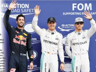  ??  ?? TOP THREE: Daniel Ricciardo,Nico Rosberg Lewis Hamilton, from left, wave on the podium at the Hockenheim circuit, after the qualifying prior to the Formula One Grand Prix of Germany on Saturday. (AFP)