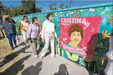  ?? Don Leach Daily Pil ot ?? THE MURALS in Costa Mesa feature Cristina Prada, center left, and Frances Muñoz, right, California’s f irst Latina judge. The project honoring 11 Latinas was conceived by Camilo Romero, Prada’s grandson.