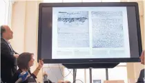  ?? PETER DEJONG/ASSOCIATED PRESS ?? A video shows the text underneath two taped off pages from Anne Frank’s diary during a press conference at The Anne Frank Foundation’s office in Amsterdam, Netherland­s, Tuesday