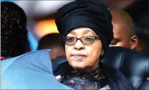  ??  ?? In this Dec. 10, 2013 file photo by The Associated Press, Winnie Madikizela-Mandela listens to speeches during the memorial service for her ex-husband, former South African president Nelson Mandela at the FNB Stadium in Soweto, Johannesbu­rg.