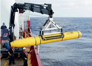  ?? Reuters ?? Crew aboard the Australian Defence Vessel Ocean Shield move the Bluefin-21 into position for deployment in the southern Indian Ocean to look for the missing plane. —