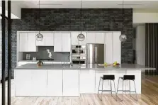  ??  ?? Charcoal-gray brick stands in stark contrast against glossy white cabinets in the kitchen.