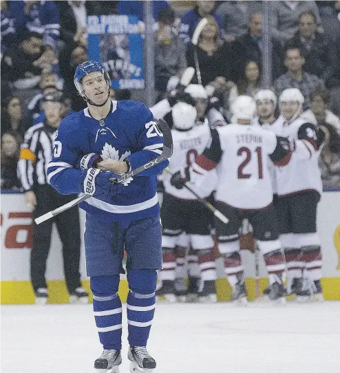  ?? PHOTOS: STAN BEHAL / POSTMEDIA NEWS ?? Maple Leafs centre Dominic Moore reacts as the Coyotes celebrate a goal at the Air Canada Centre on Monday.