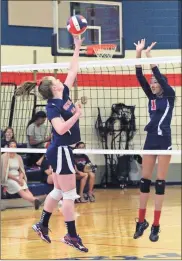  ?? / Scott Herpst ?? Saddle Ridge’s Markella Johnson goes up to try and block a shot from Heritage’s Lauren Mock during Thursday’s big NGAC match in Rock Spring. The Lady Mustangs pulled out a thrilling 25-23, 25-23 victory.