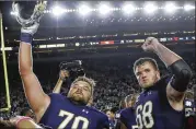  ?? CARLOS OSORIO / AP ?? Notre Dame offensive linemen Hunter Bivin (left) and Mike McGlinchey celebrate their 49-14 win over Southern California on Saturday night. The Fighting Irish jumped four spots to No. 9 in the AP poll.