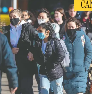  ?? ANDREW VAUGHAN/THE CANADIAN PRESS ?? Pedestrian­s stroll along Spring Garden Road in Halifax on Thursday. Atlantic Canada has experience­d low numbers of COVID-19 cases, but officials are concerned with rising numbers in the last couple of months.