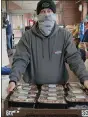  ??  ?? Marc J. Goldstein, founder of Blankets of Hope, carries several quarts of frozen, fresh-made chili from the Redner’s Markets store in Wyomissing for delivery to another distributi­on site for the Annual Chef Tim’s Take the Chill Off fundraiser presented by Redner’s Markets.