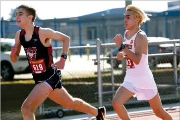  ?? RECORDER PHOTO BY NAYIRAH DOSU ?? Portervill­e High School’s Josh Jimenez chases down a Tulare Western High School runner near the finish line at a league meet, Wednesday, Feb. 17, 2021 at Tulare Western.