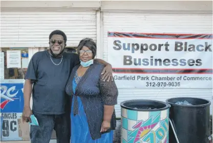  ?? PAT NABONG/SUN-TIMES PHOTOS ?? McKinley Gray, son of Percell Searcy, who owns One Eleven Food and Liquor, and Verlinda Dotson, Searcy’s niece, stand outside the store Thursday in East Garfield Park.